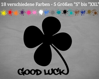 May include: Black four-leaf clover with the text "GOOD LUCK" in a stylized font. The image shows 18 different color options and 5 sizes from "S" to "XXL".