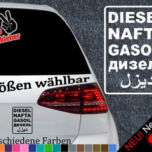 May include: A white car with a black sticker on the rear window. The sticker says "6 Größen wählbar" and features a peace sign with the words "Gratis Testaufkleber". The sticker also includes the words "DIESEL, NAFTA, GASOIL, дизель, ديزل" in various languages. The car has a red rear light and a black bumper. The sticker is available in 21 different colours.