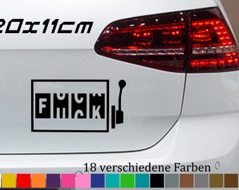 May include: A white car with a black decal that says "F*CK" in a slot machine style with a lever. The decal is 20 x 11 cm. The car has a red taillight. The text "18 verschiedene Farben" is below the decal.