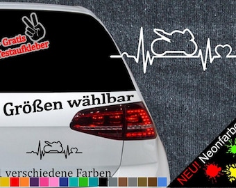 May include: A white car with a black rear window and a sticker on the back. The sticker is a white silhouette of a motorcycle with a heart beat line and the text "6 Größen wählbar" and "21 verschiedene Farben".