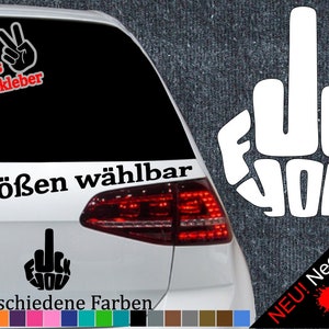 May include: A white car with a black and white sticker that says "F**k You" on the back window. The sticker is in the shape of a middle finger. The car also has a sticker that says "6 Größen wählbar" and "21 verschiedene Farben".