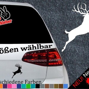 Könnte beinhalten: Ein schwarz-weißer Hirsch-Silhouetten-Aufkleber mit dem Text "6 Größen wählbar" und "21 verschiedene Farben". Der Aufkleber befindet sich auf der Heckklappe eines Autos mit einem roten Rücklicht. Der Text "NEU! Neonfarben" befindet sich in der unteren rechten Ecke des Bildes.