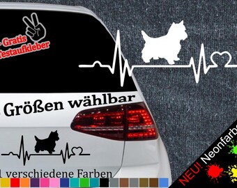 May include: A white car with a black and white decal of a dog with a heartbeat. The decal says "6 Größen wählbar" and "21 verschiedene Farben".