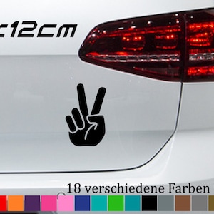 May include: A black peace sign sticker on a white car. The sticker is 18 x 12 cm. The car has a red rear light. The sticker is available in 18 different colours.