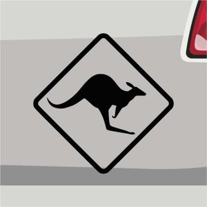 May include: Black and white warning sign with a silhouette of a kangaroo inside a diamond shape.