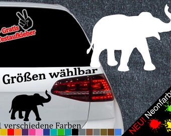 May include: A white car with a black elephant sticker on the back window. The sticker says "6 Größen wählbar" and "21 verschiedene Farben". There is also a sticker of a peace sign with the text "+ Gratis Testaufkleber".