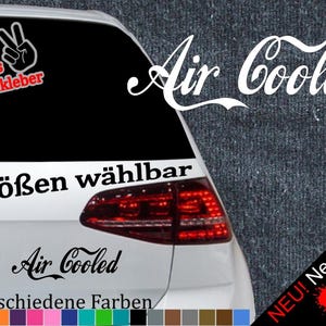 May include: A white car with a black and white sticker that says "Air Cooled" in a stylized font. The sticker is on the back window of the car. The sticker is available in 6 sizes and 21 colors. The sticker also includes a free test sticker.