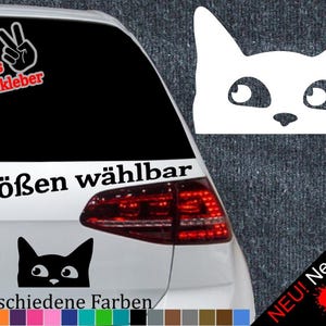 May include: A black cat sticker with white eyes and a white peace sign sticker with the text "+ Gratis Testaufkleber" on a black car. The car has a red taillight and the text "6 Größen wählbar" and "21 verschiedene Farben" on the back. The text "NEU! Neonfarben" is in the bottom right corner of the image.