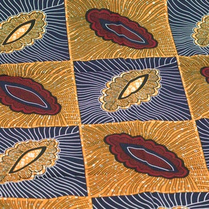 May include: A fabric with a repeating pattern of stylized leaves in shades of gold, brown, red, and blue. The leaves are outlined in black and have a textured appearance.