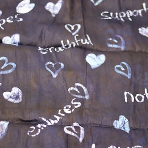 Love attributes African adire batik hand printed shapes in colours fabric sold by the Yard