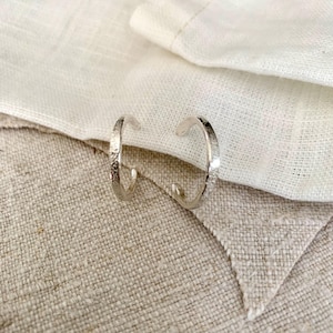 Rustic textured slim medium hoop earrings in recycled silver.