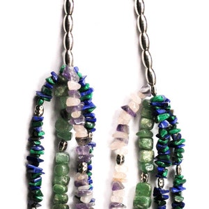 May include: A multi-strand necklace with green, blue, and purple gemstone beads. The necklace has silver clasps and is made of natural stones.