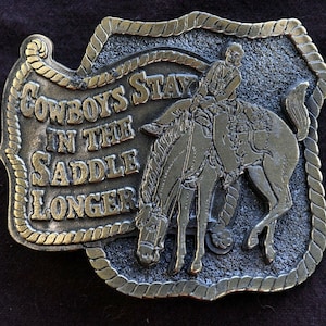 1980 Cowboys Stay in the Saddle Longer 3 3/4&quot; x 2 3/4&quot; Brass Belt Buckle 5.8 oz