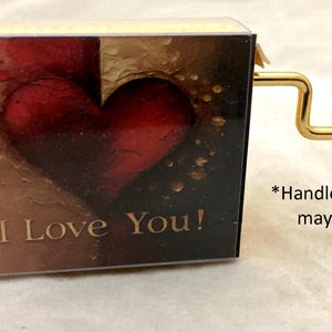 Hand cranked music box playing Slipping Through My Fingers from Mamma Mia!