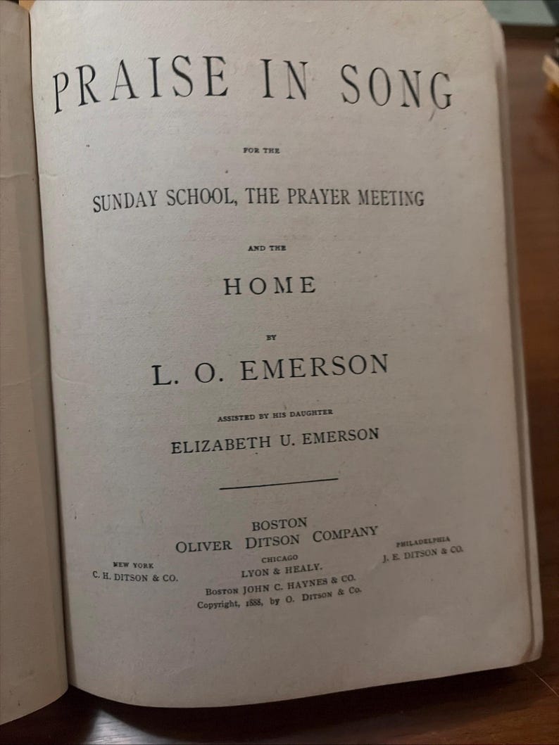 May include: Open book with the title "PRAISE IN SONG" at the top. The text below reads "FOR THE SUNDAY SCHOOL, THE PRAYER MEETING AND THE HOME". The book is by L. O. EMERSON, assisted by his daughter, ELIZABETH U. EMERSON. Published by OLIVER DITSON COMPANY.