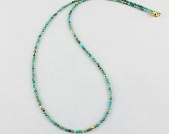 May include: A turquoise and gold beaded necklace. The necklace is made of small, round beads that are strung together on a gold chain.