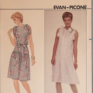 May include: Butterick pattern 4426 size 10 Evan-Picone sewing pattern envelope. The front displays two dress variations: a grey floral print dress with ruffled sleeves and a waist tie, and a white sleeveless dress with ruffled shoulders.
