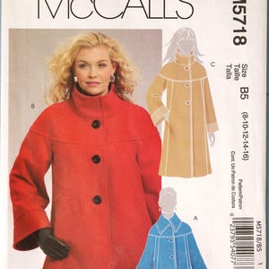 May include: A McCall's M5718 sewing pattern envelope featuring illustrations of three coat variations. The main image shows a red coat with a high collar and three black buttons. Smaller illustrations show a tan coat and a blue coat.