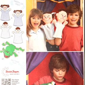 May include: Simplicity pattern 1729 featuring hand puppets. The pattern includes instructions for making happy and sad face puppets, and a green frog puppet. The image shows children with the puppets and the text "Happy or Sad!!".
