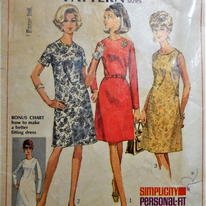 May include: A vintage Simplicity 7509 sewing pattern envelope for a dress in half-sizes. The cover features illustrations of three dresses: a black and white floral print, a solid red dress, and a yellow floral print, plus a bonus chart for fitting.