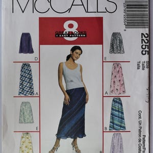 May include: McCall's sewing pattern 2255 for a skirt with 8 variations. The envelope features a central image of a person wearing a dark blue skirt and a light gray tank top, surrounded by illustrations of various skirt styles in different colors and patterns.