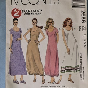 May include: McCall's sewing pattern for a 2-hour dress. The pattern features illustrations of four different dress styles, including a floral print, a solid tan, a pink, and a white dress with a patterned hem. The pattern number is 2688, size B (8-10-12).