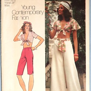 May include: A Simplicity 5695 sewing pattern envelope for a size 8, featuring a bust of 31.5 inches and a waist of 24 inches. The cover displays illustrations and photographs of a tie-front crop top paired with either pink knee-length shorts or white wide-leg trousers.