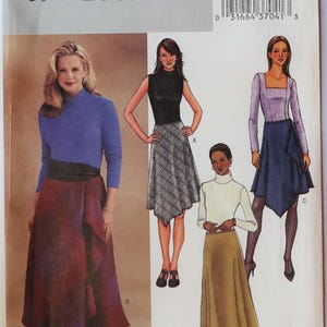 May include: Butterick sewing pattern 3971 featuring illustrations of four skirt variations. The designs include a plaid skirt, a solid tan skirt, and a dark blue skirt with an asymmetrical hemline. The pattern envelope displays a barcode and text.