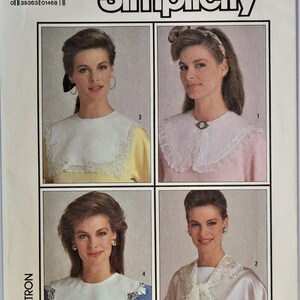 May include: Simplicity sewing pattern 7995 for one size collars. The envelope features four illustrations of collars with lace trim, including a plain white collar, a collar with a central brooch, a pointed lace collar, and a draped lace scarf style.