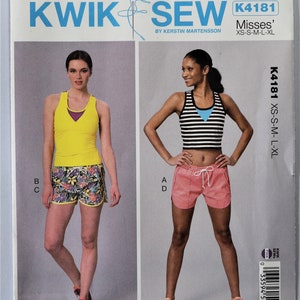 May include: Kwik Sew pattern K4181 featuring athletic wear designs. The pattern includes a yellow tank top with a purple underlayer, floral shorts, and a black and white striped crop top with pink shorts. Sizes XS-L.