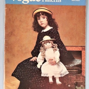 May include: Vogue Patterns 637 sewing pattern envelope featuring a photograph of a person wearing a dark floral dress and a yellow-trimmed hat, holding a doll with curly hair wearing a white dress and a matching yellow-trimmed hat, designed by Linda Carr.