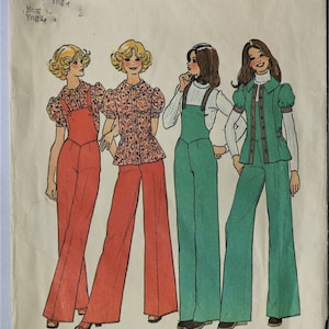 May include: Vintage Simplicity sewing pattern 7187 featuring illustrations of four women in 1970s outfits. The outfits include jumpsuits, overalls, and blouses in shades of red, green, and white. The pattern is on a blue and white background.