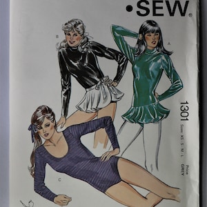 May include: Kwik Sew pattern 1301 featuring illustrations of women's clothing designs. The pattern includes a black turtleneck top with a white skirt, a green top with a ruffled hem, and a purple bodysuit. Sizes XS-L.