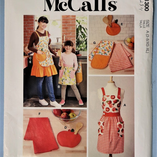 McCall's 8234.  McCall's R11300.  Apron, pot holders, tea towels pattern.  Adult/child full cover or half apron, accessories pattern. Uncut
