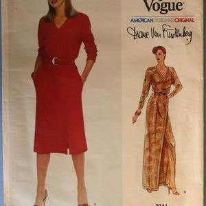 May include: A vintage Vogue sewing pattern featuring a red dress with a belt and a split skirt. The pattern includes a second dress design with a wrap style and long sleeves. The text "Very Easy Vogue" and "Diane Von Furstenberg" are visible.