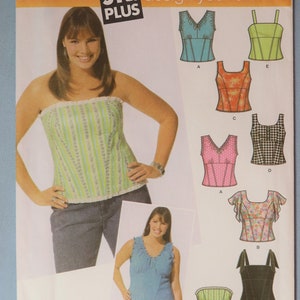 May include: Simplicity pattern 5009, featuring a woman wearing a green and white striped tube top. The pattern includes designs for various tops, including a pink polka dot top, a floral top, and a black top with straps.