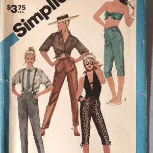 May include: A Simplicity 6461 sewing pattern envelope for size 10, 25-inch waist. The illustration features four outfits: a striped shirt with suspenders and trousers, a plaid shirt with trousers and hat, a teal crop top with capris, and a halter top with leopard print capris.