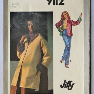 May include: Simplicity sewing pattern 9112. The pattern features illustrations of a long coat and a jacket with pants. The coat is a light yellow with brown trim. The jacket is red with green trim and is paired with blue pants.
