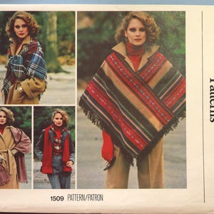 May include: A Vogue Patterns 1509 sewing pattern envelope featuring four illustrations of outerwear garments. The designs include a plaid shawl, a solid red scarf, a textured wrap, and a striped poncho with fringe, all displayed on a beige background.