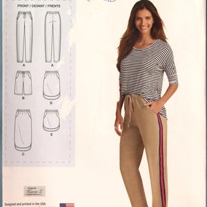 May include: Simplicity sewing pattern 1428 U5, featuring a woman wearing a striped top and tan pants with a red and navy stripe. The pattern includes diagrams for pants, shorts, and a skirt. Sizes XL-XXL.