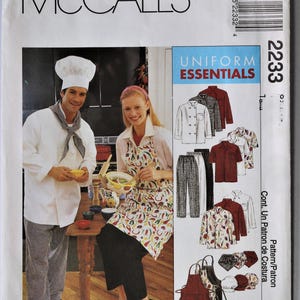 May include: McCall's sewing pattern for Uniform Essentials. The pattern features images of chef coats, aprons, and pants. The cover shows a chef and a woman wearing a chef's hat and apron. The pattern number is 2233.