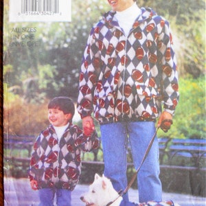 May include: A Butterick Father & Son sewing pattern featuring a matching jacket design for a father, child, and dog. The jackets have a repeating pattern of footballs within a diamond grid. The pattern includes all sizes in one envelope.