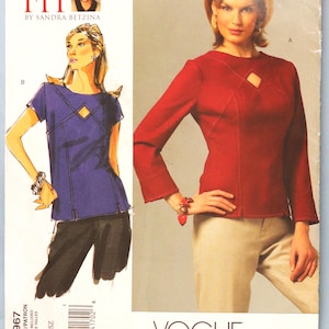 May include: Vogue Patterns sewing pattern V2967. The pattern features illustrations of two tops. One is a long-sleeved red top with a keyhole detail. The other is a short-sleeved purple top. The text "TODAY'S FIT" and "VOGUE PATTERNS" are visible.