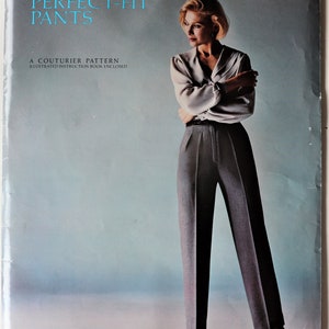 May include: A sewing pattern envelope titled Leonora's PERFECT-FIT PANTS, A COUTURIER PATTERN, ILLUSTRATED INSTRUCTION BOOK ENCLOSED, 111E, Hip 50-55 inches. The cover features a person wearing a light gray blouse and dark gray trousers.