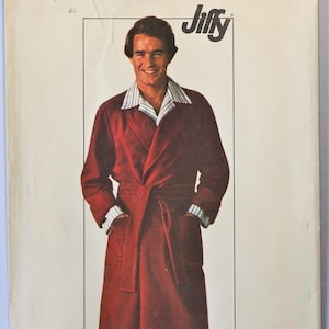 May include: A Simplicity Jiffy sewing pattern envelope 7741 featuring a maroon robe with a tie waist and two front pockets. The envelope displays the text 7741, Simplicity, Jiffy, and a price of $1.50, with Canada 1.60 printed in the upper corner.