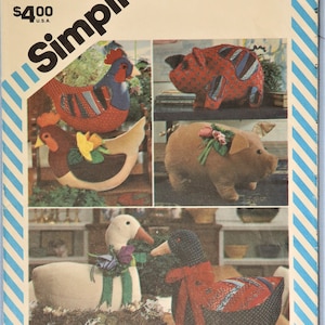 May include: Simplicity pattern 6148 featuring stuffed animal designs. The pattern includes instructions for making a rooster, hen, pig, and two ducks. The animals are made from fabric and decorated with various embellishments.