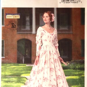 May include: Butterick B5832 sewing pattern for a historical dress. The pattern features a woman in a white dress with pink floral print, long sleeves, and a V-neck. The pattern includes sizes A5 (6-8-10-12-14).