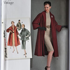 May include: Vintage Simplicity sewing pattern from the 1950s. The pattern features a woman in a long red coat and a dress. The pattern also shows illustrations of other coat and dress designs. The Simplicity logo is visible.