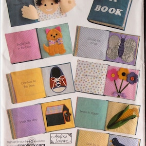 May include: Simplicity sewing pattern 3709 for a fabric activity book. The cover shows a blue book titled MY BOOK. Inside pages feature interactive elements including a peek-a-boo face, a cat, a butterfly, a shoe, flowers, a dog house, corn, and a bird.