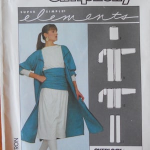 May include: Simplicity sewing pattern 8726 featuring a woman modeling a teal duster coat, white top, and pants. The pattern includes instructions for an overlock/serger machine. The text "Super Simple Elements" is visible.